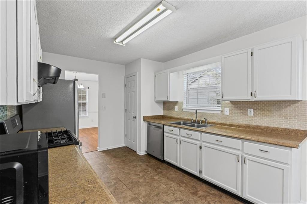 2242 Rocksram Court Buford, GA 30519 - Photo 18 of 52 a kitchen with a sink stove and cabinets
