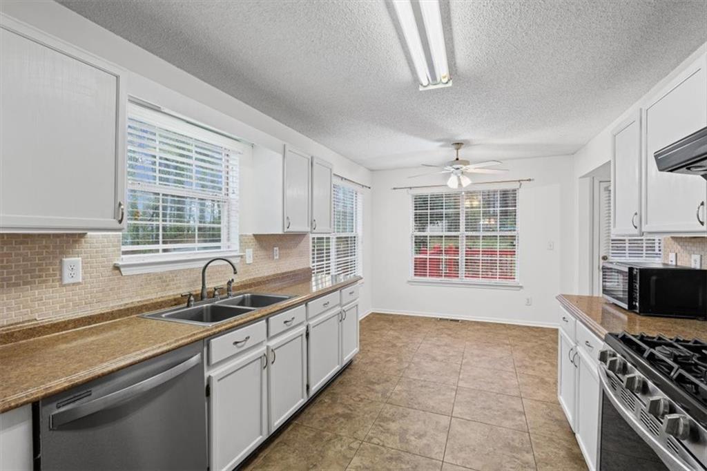 2242 Rocksram Court Buford, GA 30519 - Photo 20 of 52 a kitchen with a sink stove and cabinets