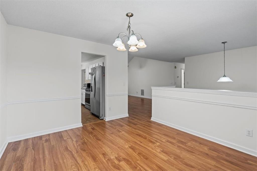 2242 Rocksram Court Buford, GA 30519 - Photo 23 of 52 a view of a kitchen with a dishwasher cabinets and wooden floor
