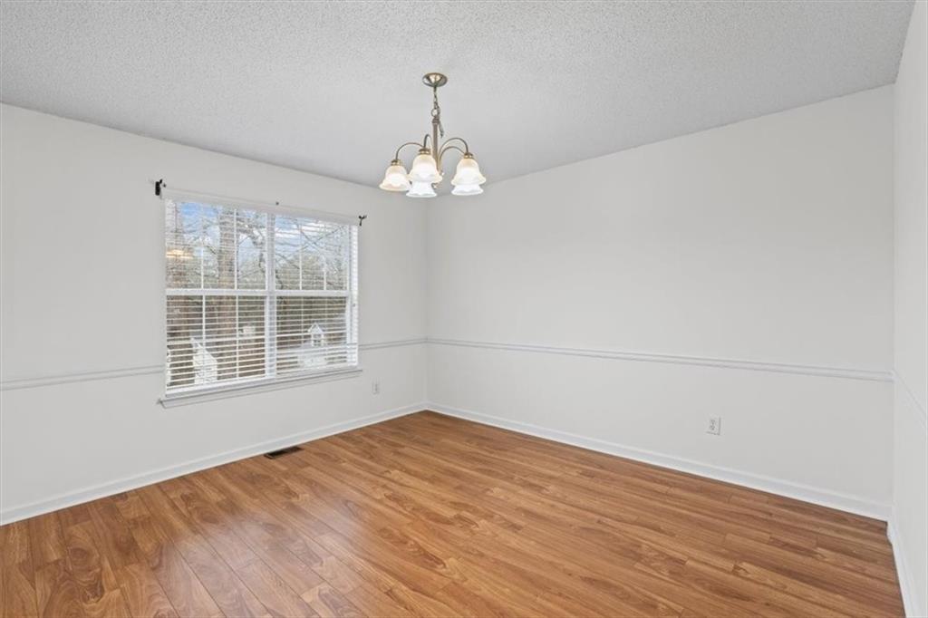 2242 Rocksram Court Buford, GA 30519 - Photo 24 of 52 a view of empty room with wooden floor and fan
