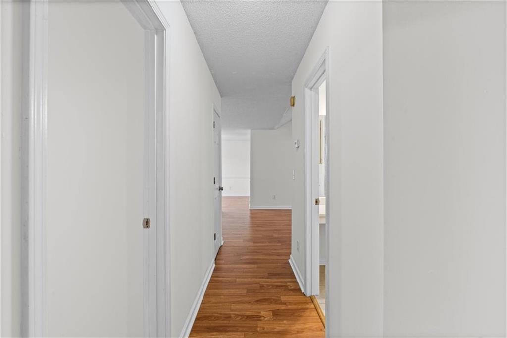 2242 Rocksram Court Buford, GA 30519 - Photo 26 of 52 a view of a hallway with wooden floor