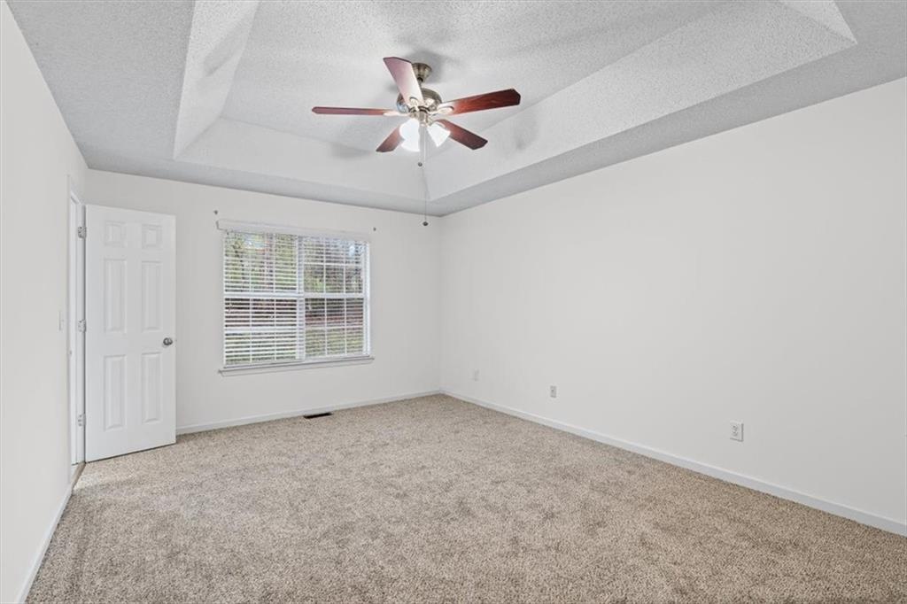 2242 Rocksram Court Buford, GA 30519 - Photo 27 of 52 an empty room with windows and fan