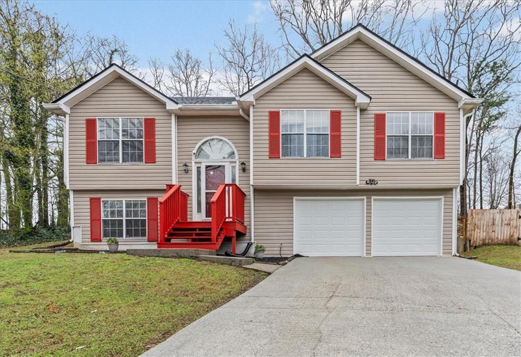 2242 Rocksram Court Buford, GA 30519 - Photo 3 of 52 a front view of a house with garden