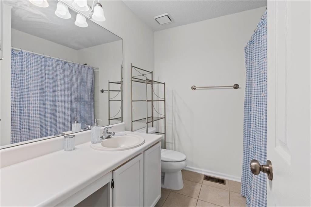 2242 Rocksram Court Buford, GA 30519 - Photo 32 of 52 a bathroom with a sink toilet and shower