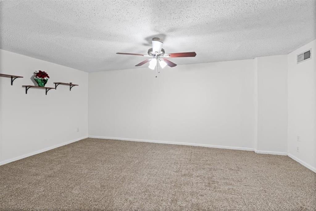 2242 Rocksram Court Buford, GA 30519 - Photo 33 of 52 a view of a big room with chandelier fan