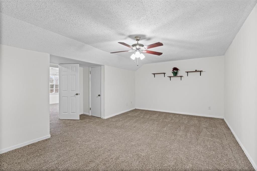 2242 Rocksram Court Buford, GA 30519 - Photo 35 of 52 a view of an empty room with a ceiling fan