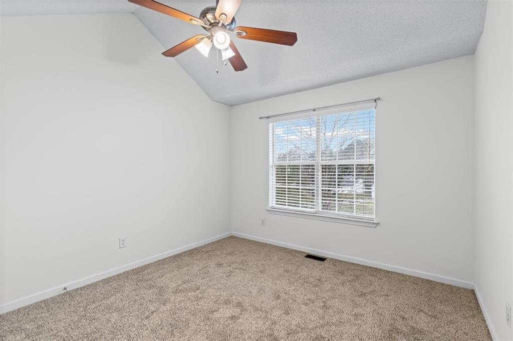 2242 Rocksram Court Buford, GA 30519 - Photo 37 of 52 an empty room with a window and a fan