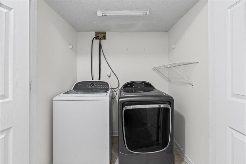 2242 Rocksram Court Buford, GA 30519 - Photo 41 of 52 a view of storage and utility room with a washer and dryer