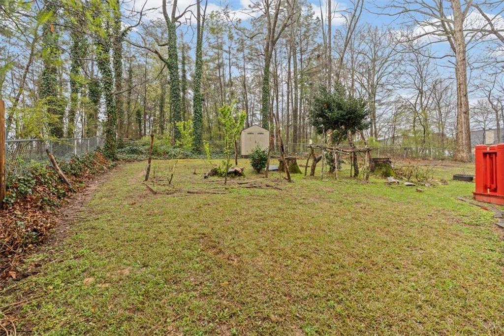 2242 Rocksram Court Buford, GA 30519 - Photo 47 of 52 a backyard of a house with table and chairs