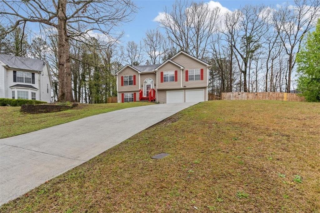 2242 Rocksram Court Buford, GA 30519 - Photo 5 of 52 a front view of a house with garden
