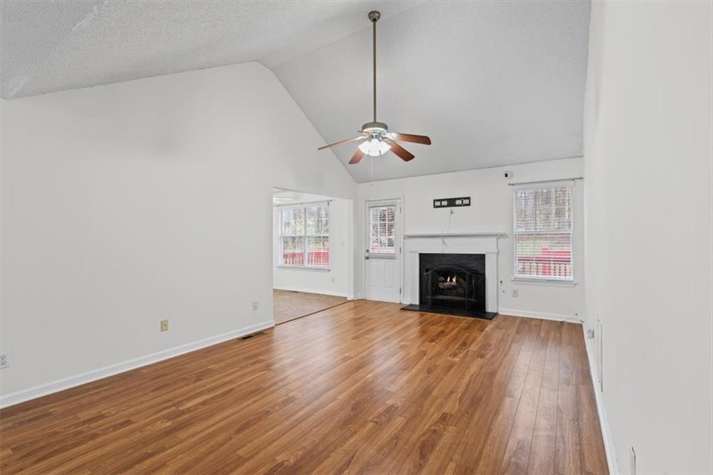 2242 Rocksram Court Buford, GA 30519 - Photo 10 of 52 a view of an empty room with wooden floor fireplace and a window