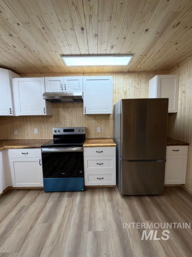 124 Windmill Lane Kooskia, ID 83539 - Photo 11 of 47 Kitchen featuring white cabinetry, stainless steel appliances, light wood-style flooring, wood ceiling, and wood walls