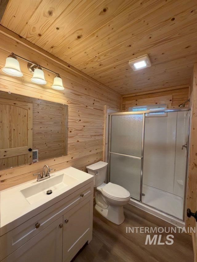 124 Windmill Lane Kooskia, ID 83539 - Photo 25 of 47 Full bath featuring vanity, wooden walls, a stall shower, dark wood-style flooring, and wooden ceiling