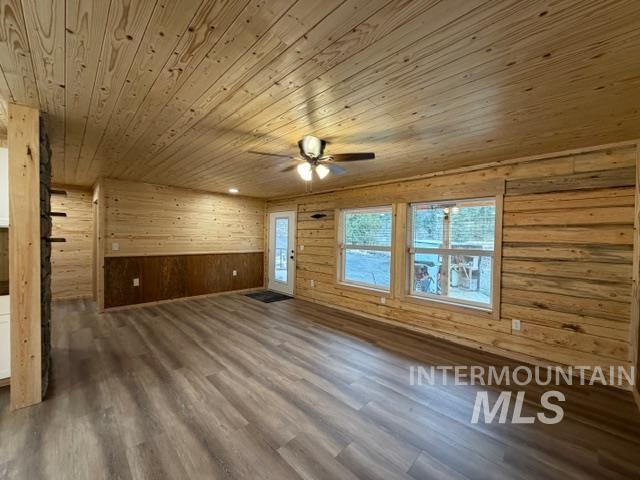 124 Windmill Lane Kooskia, ID 83539 - Photo 31 of 47 Unfurnished room featuring wood walls, dark wood-style flooring, ceiling fan, and wood ceiling