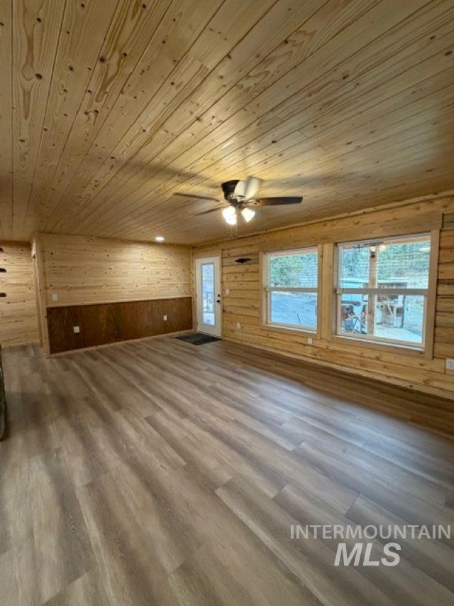 124 Windmill Lane Kooskia, ID 83539 - Photo 34 of 50 Bonus room with wooden walls, dark wood finished floors, a ceiling fan, and wood ceiling