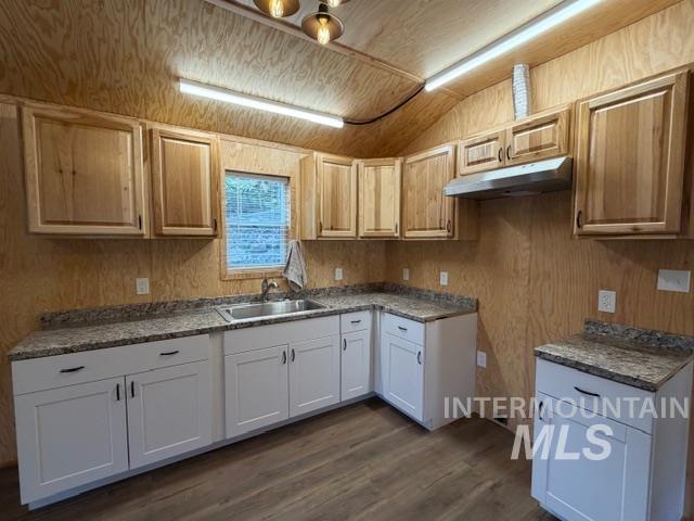 124 Windmill Lane Kooskia, ID 83539 - Photo 38 of 47 Kitchen featuring dark wood finished floors, wooden walls, and vaulted ceiling