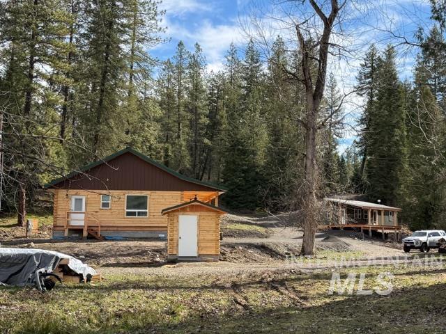 124 Windmill Lane Kooskia, ID 83539 - Photo 5 of 47 View of side of property with a storage unit and a wooded view