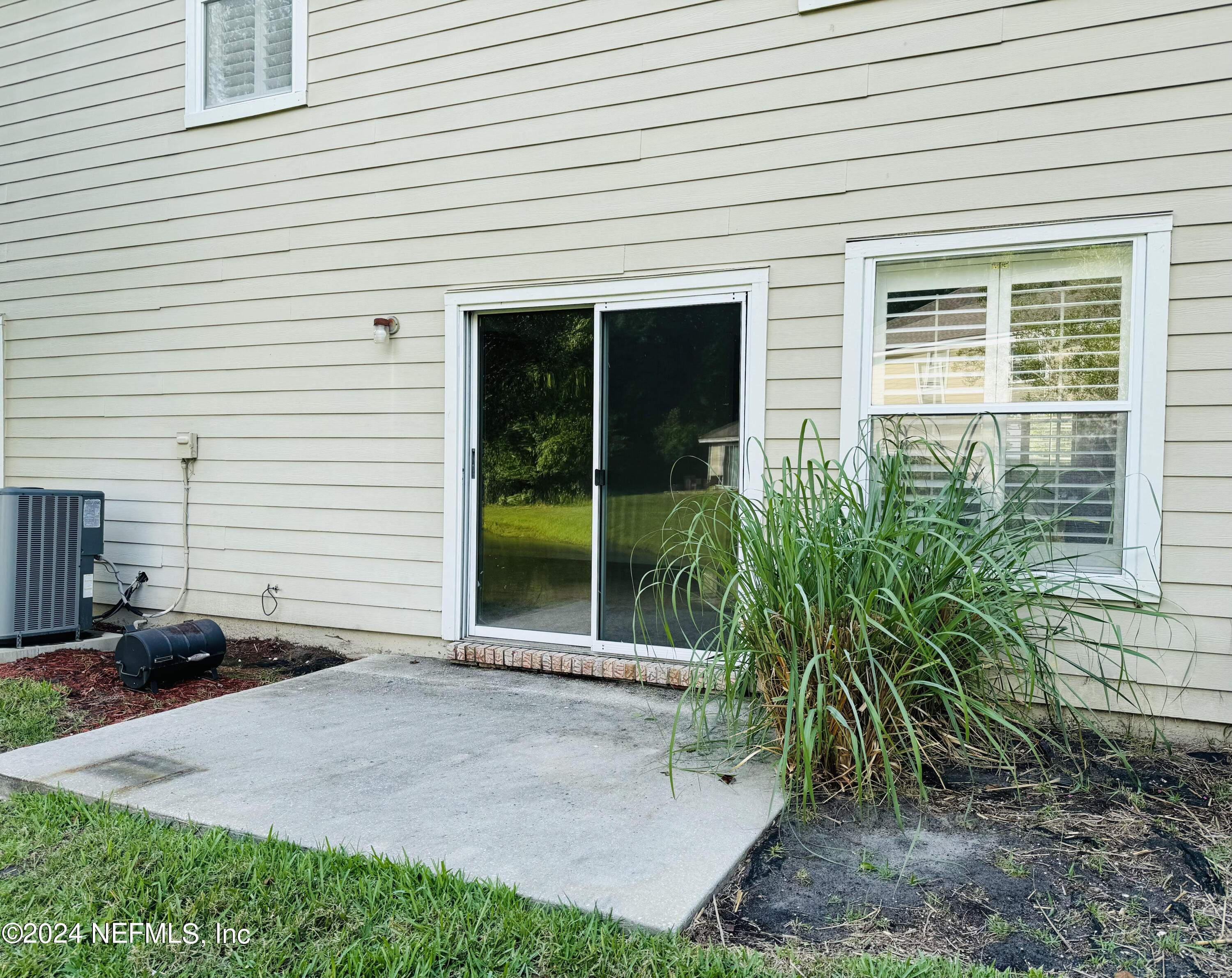 305 Blue Lake Road, Unit 2 St. Johns, FL 32259 - Photo 12 of 45 a view of a house with sitting area and potted plants