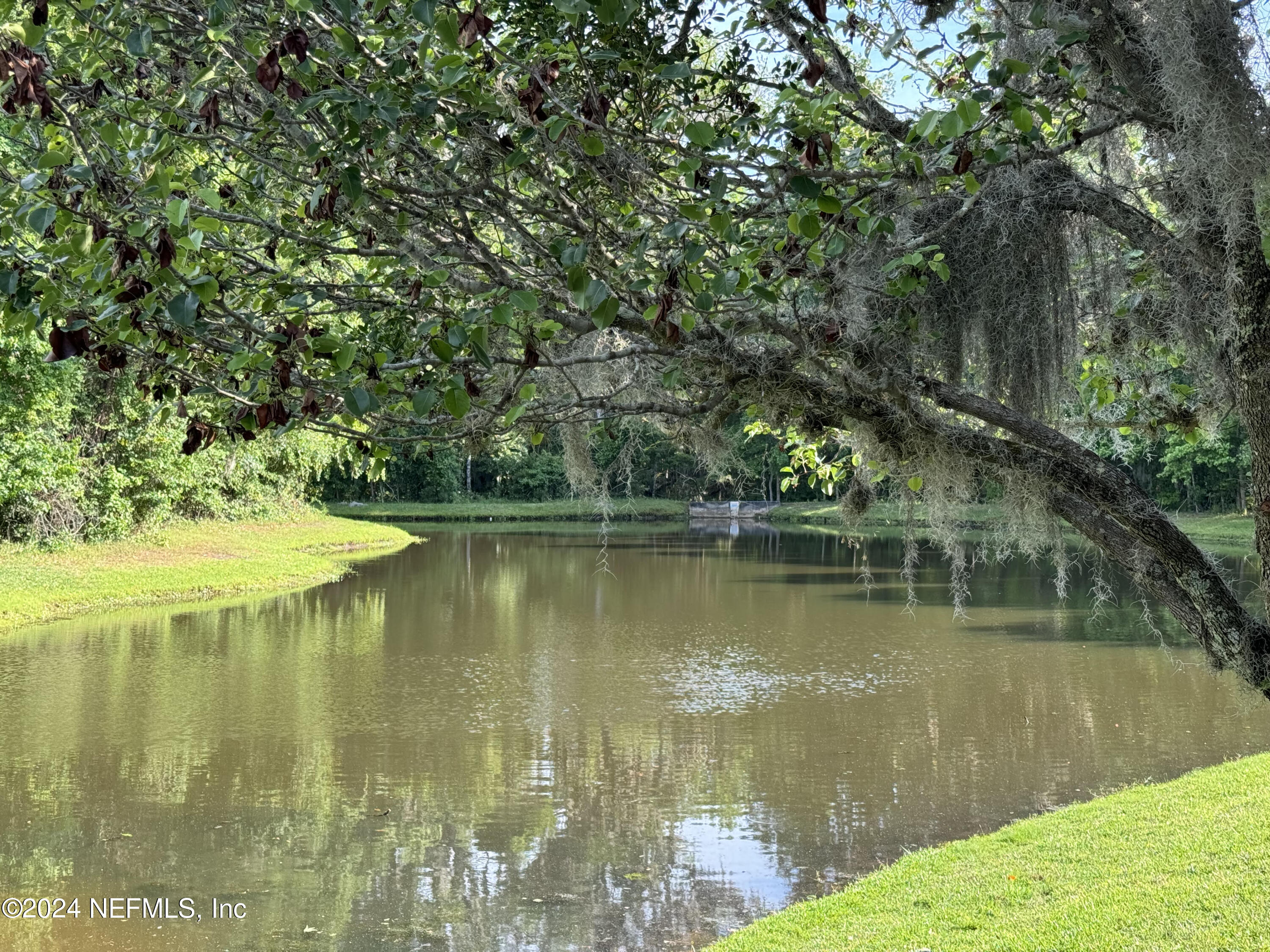 305 Blue Lake Road, Unit 2 St. Johns, FL 32259 - Photo 13 of 45 a view of a lake with a yard