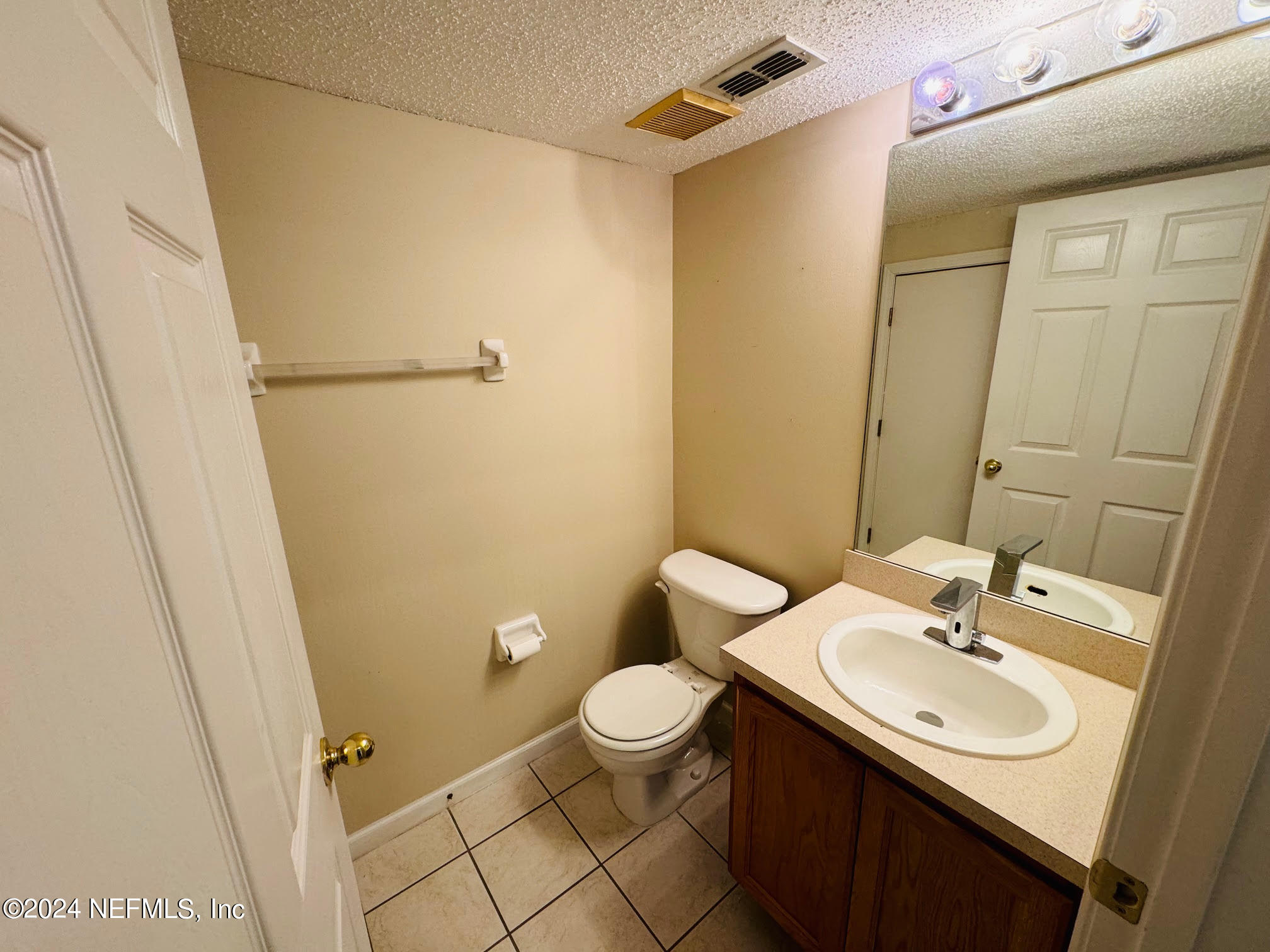 305 Blue Lake Road, Unit 2 St. Johns, FL 32259 - Photo 14 of 45 a bathroom with a sink a toilet a mirror and shower