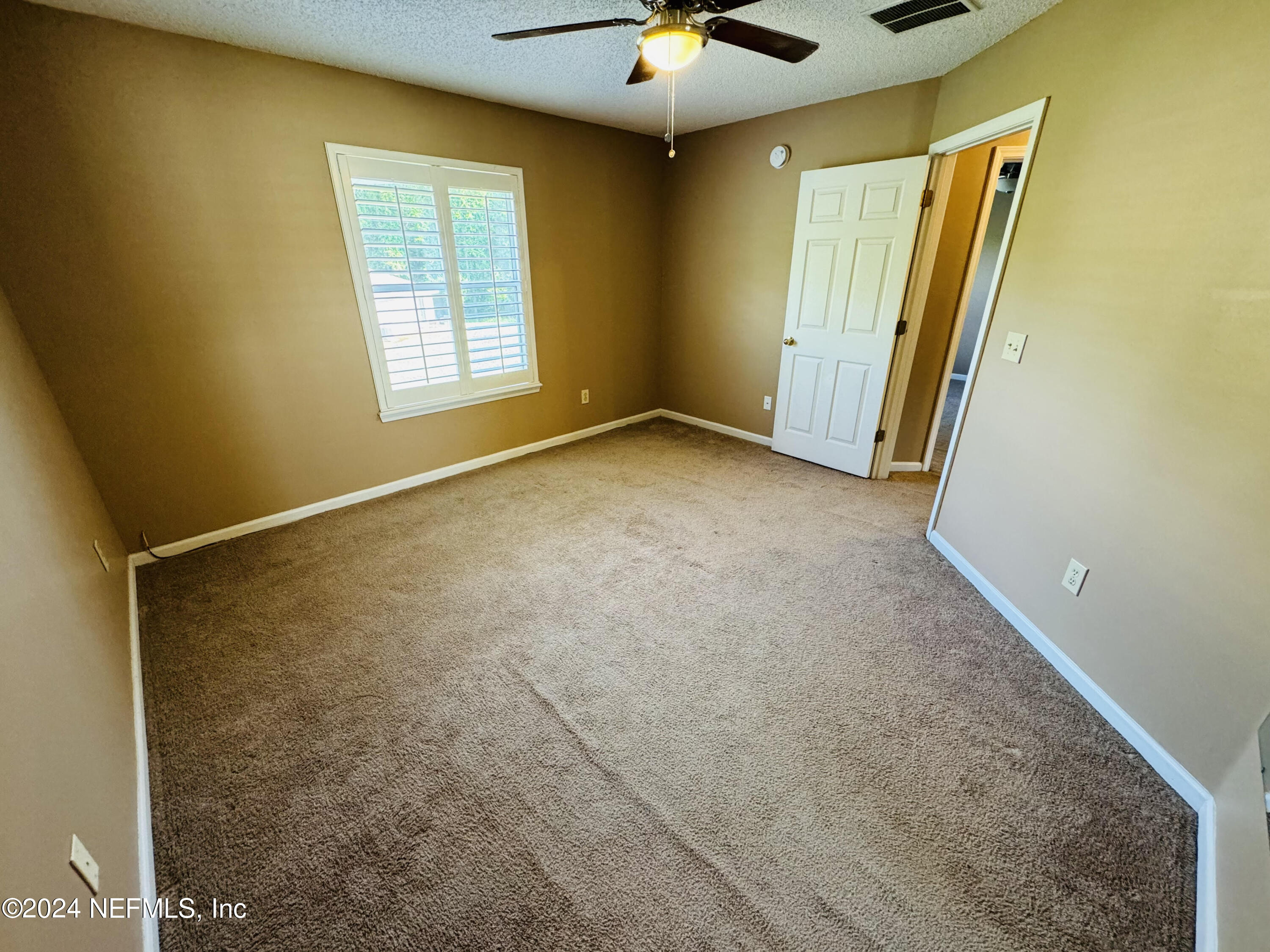 305 Blue Lake Road, Unit 2 St. Johns, FL 32259 - Photo 18 of 45 a view of an empty room with a window