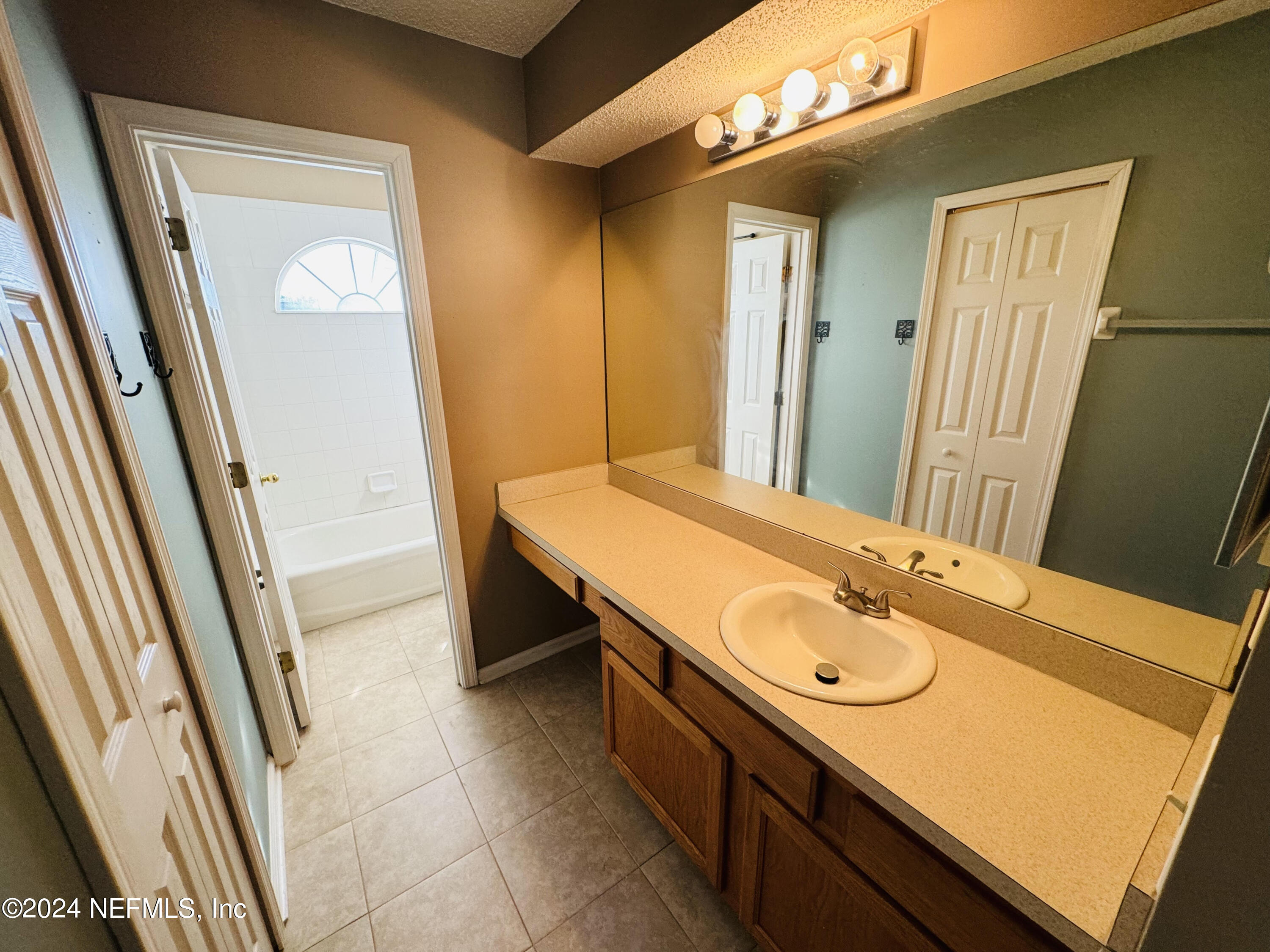 305 Blue Lake Road, Unit 2 St. Johns, FL 32259 - Photo 20 of 45 a bathroom with a sink a mirror and a shower