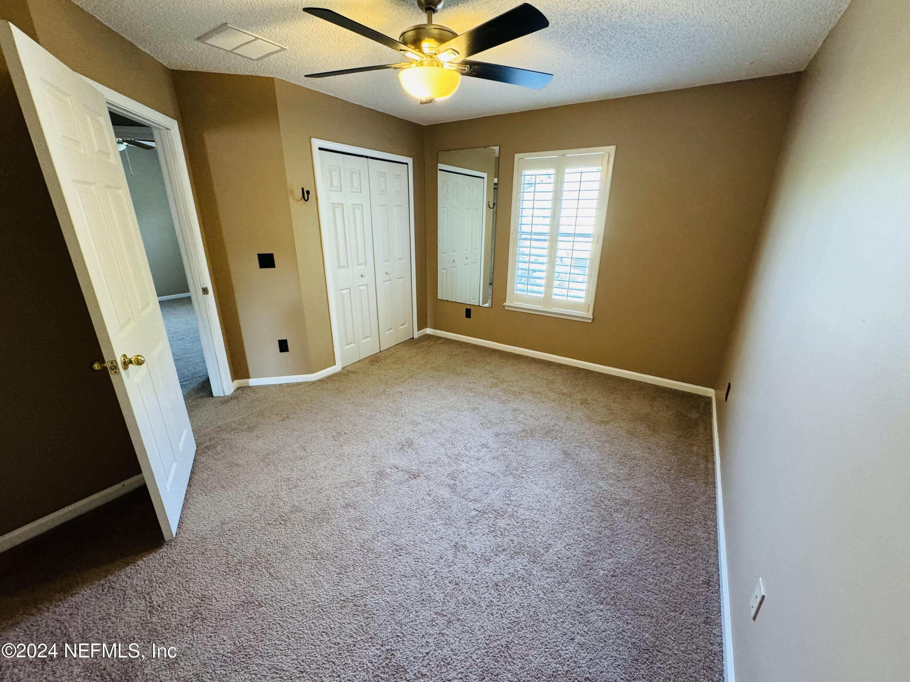 305 Blue Lake Road, Unit 2 St. Johns, FL 32259 - Photo 27 of 45 an empty room with windows and entrance