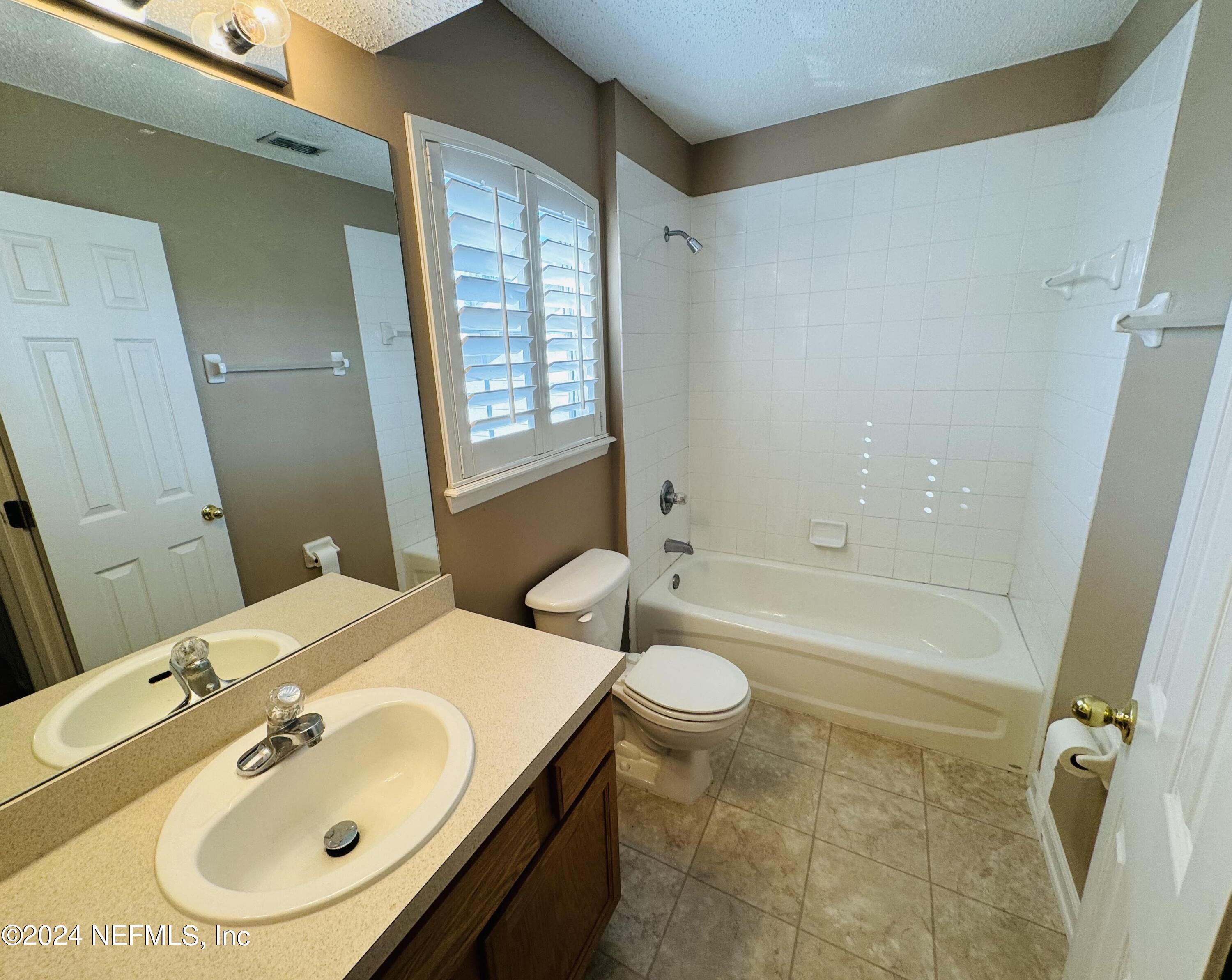 305 Blue Lake Road, Unit 2 St. Johns, FL 32259 - Photo 29 of 45 a bathroom with a sink toilet and shower