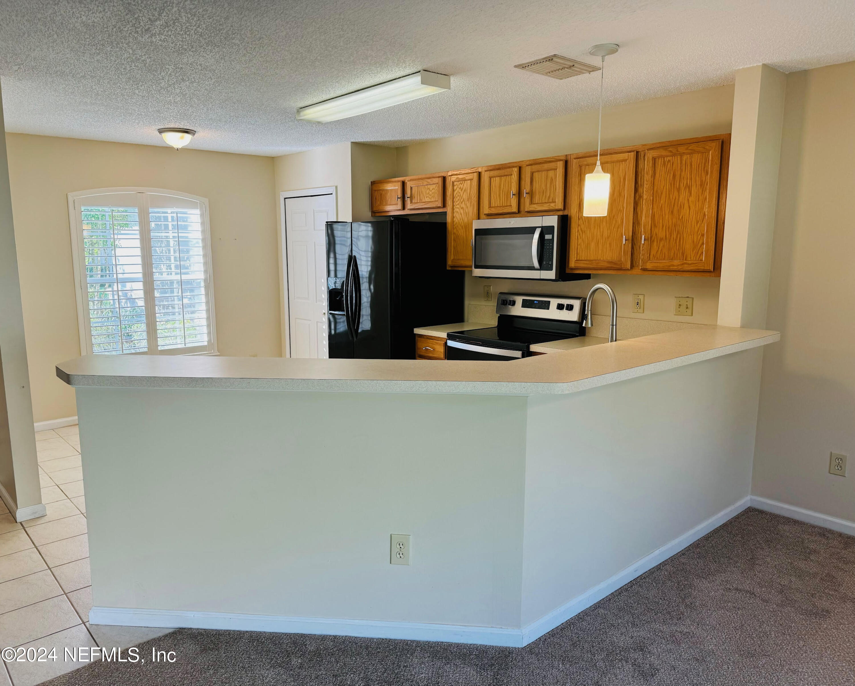 305 Blue Lake Road, Unit 2 St. Johns, FL 32259 - Photo 7 of 45 a kitchen with a refrigerator and a stove top oven