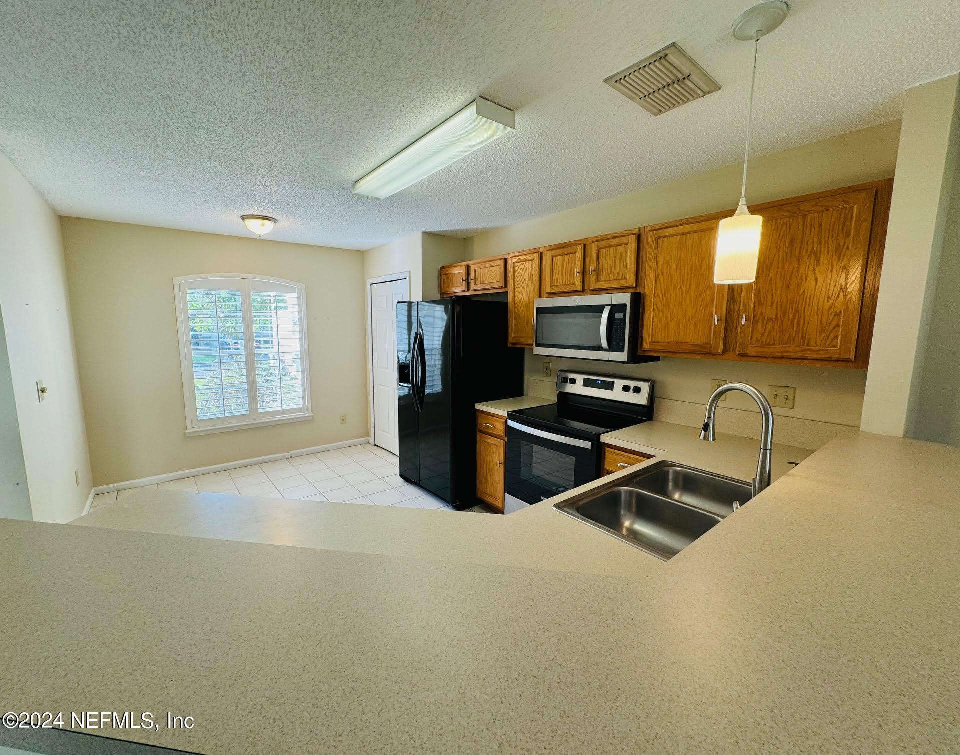 305 Blue Lake Road, Unit 2 St. Johns, FL 32259 - Photo 9 of 45 a kitchen with granite countertop a stove and a sink