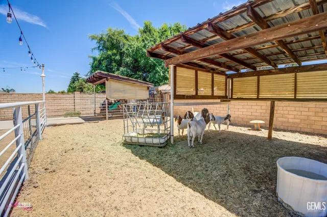 an aerial view of a house with garden space and a street view