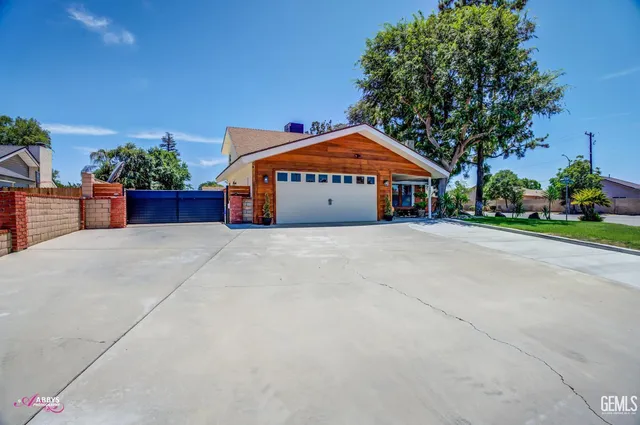 a view of a house with a yard and potted plants