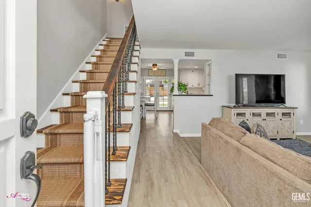 a living room with furniture and a flat screen tv