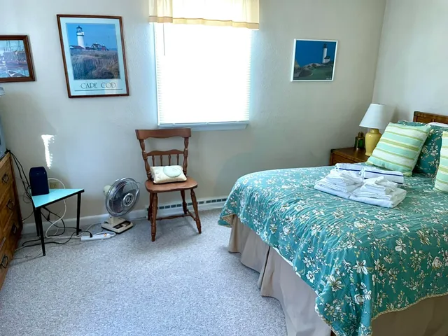 a room with a bed and a chair in it