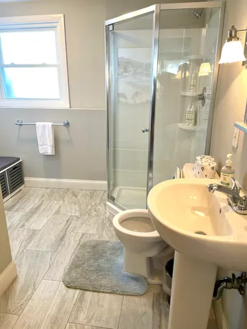 a bathroom with a sink toilet and shower