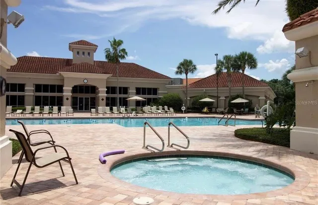 a view of a house with swimming pool and sitting area