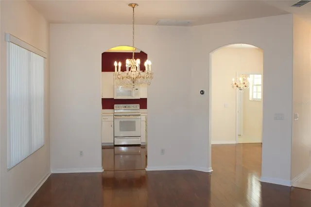 a view of a room with wooden floor and cabinet