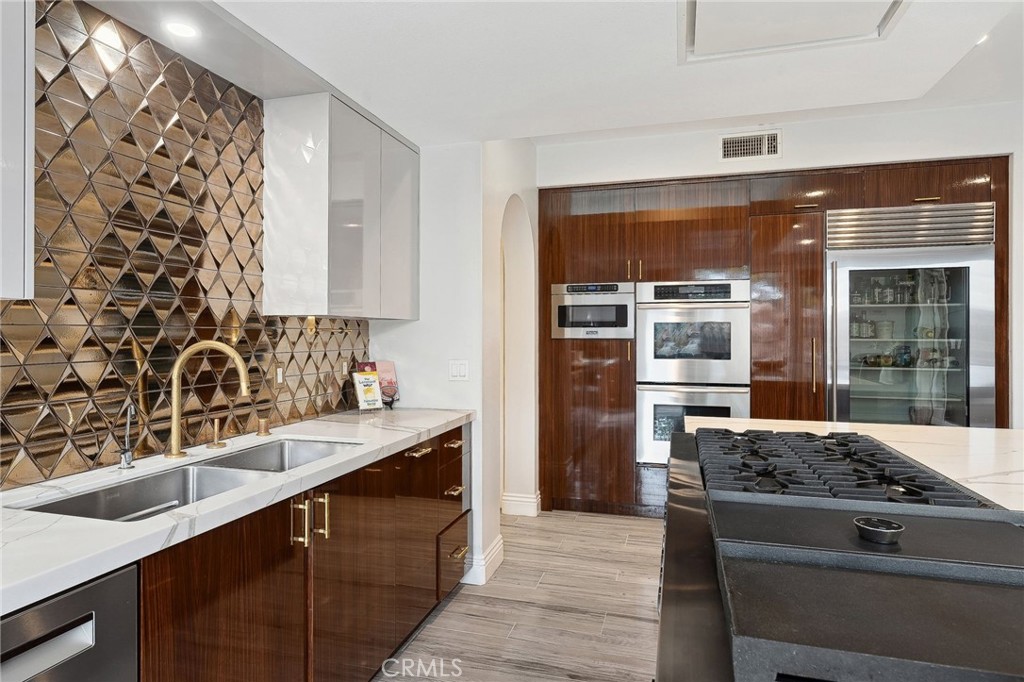 33 Basilica Place Ladera Ranch, CA 92694 - Photo 18 of 61 a kitchen with a sink stove and refrigerator