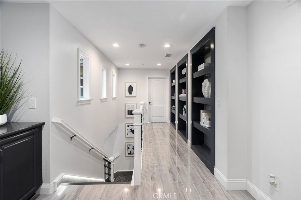 33 Basilica Place Ladera Ranch, CA 92694 - Photo 39 of 61 a view of a hallway with wooden floor and staircase