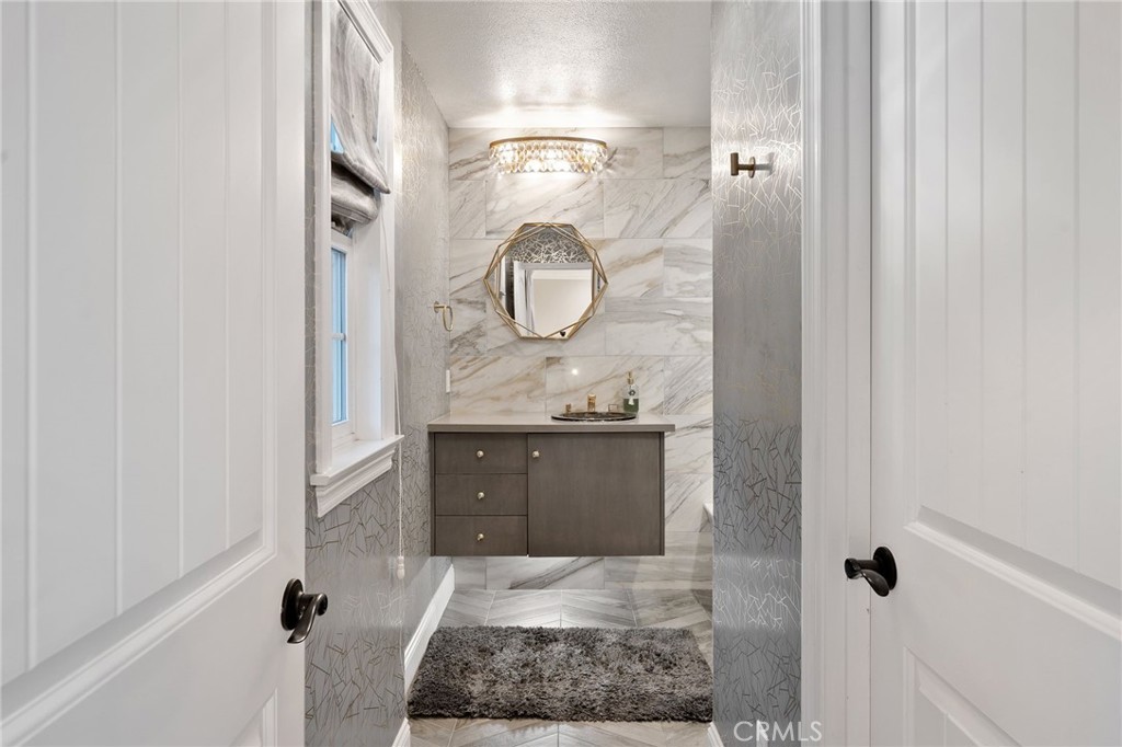 33 Basilica Place Ladera Ranch, CA 92694 - Photo 42 of 61 a bathroom with a granite countertop sink and a mirror