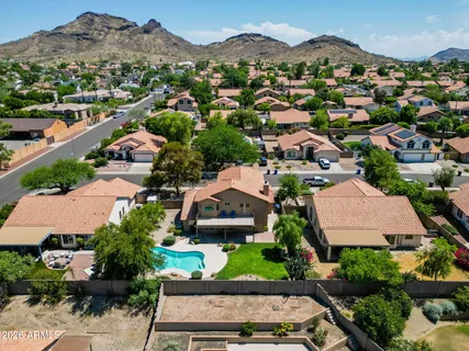 an aerial view of a house with a yard