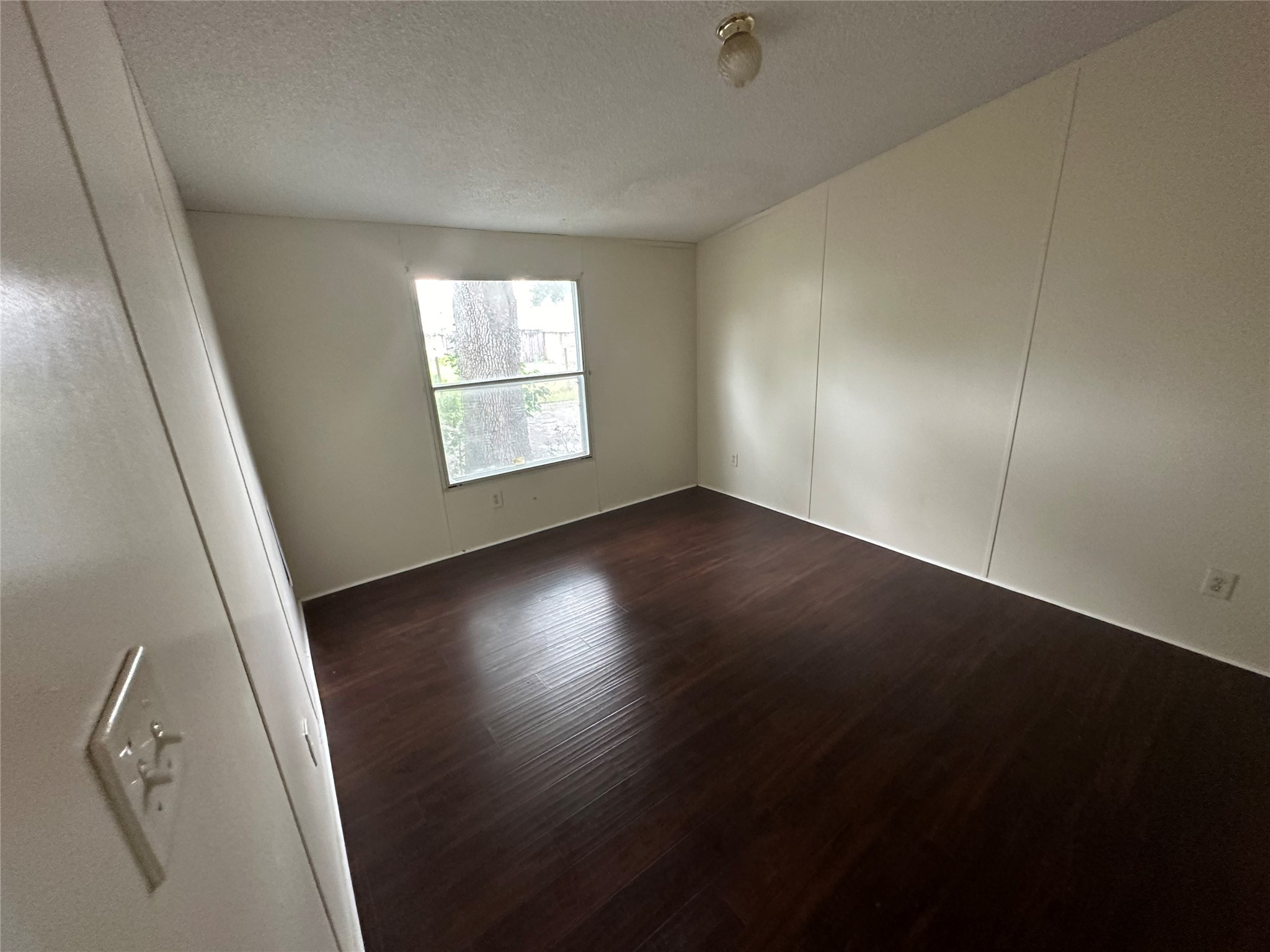 2131 Cromwell Street, Unit D Houston, TX 77093 - Photo 11 of 26 an empty room with wooden floor and windows
