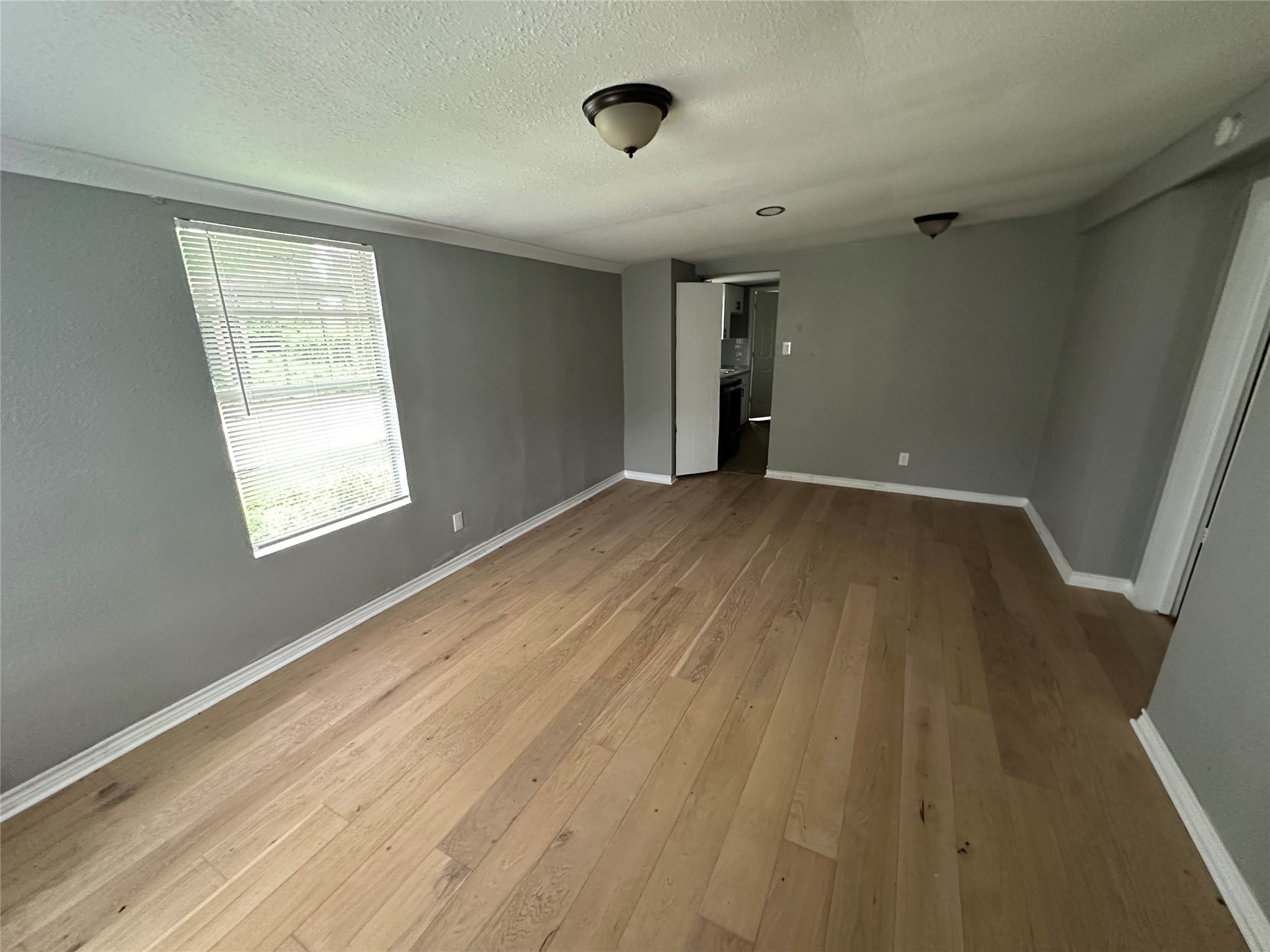 2131 Cromwell Street, Unit D Houston, TX 77093 - Photo 12 of 26 a view of an empty room with wooden floor and a window