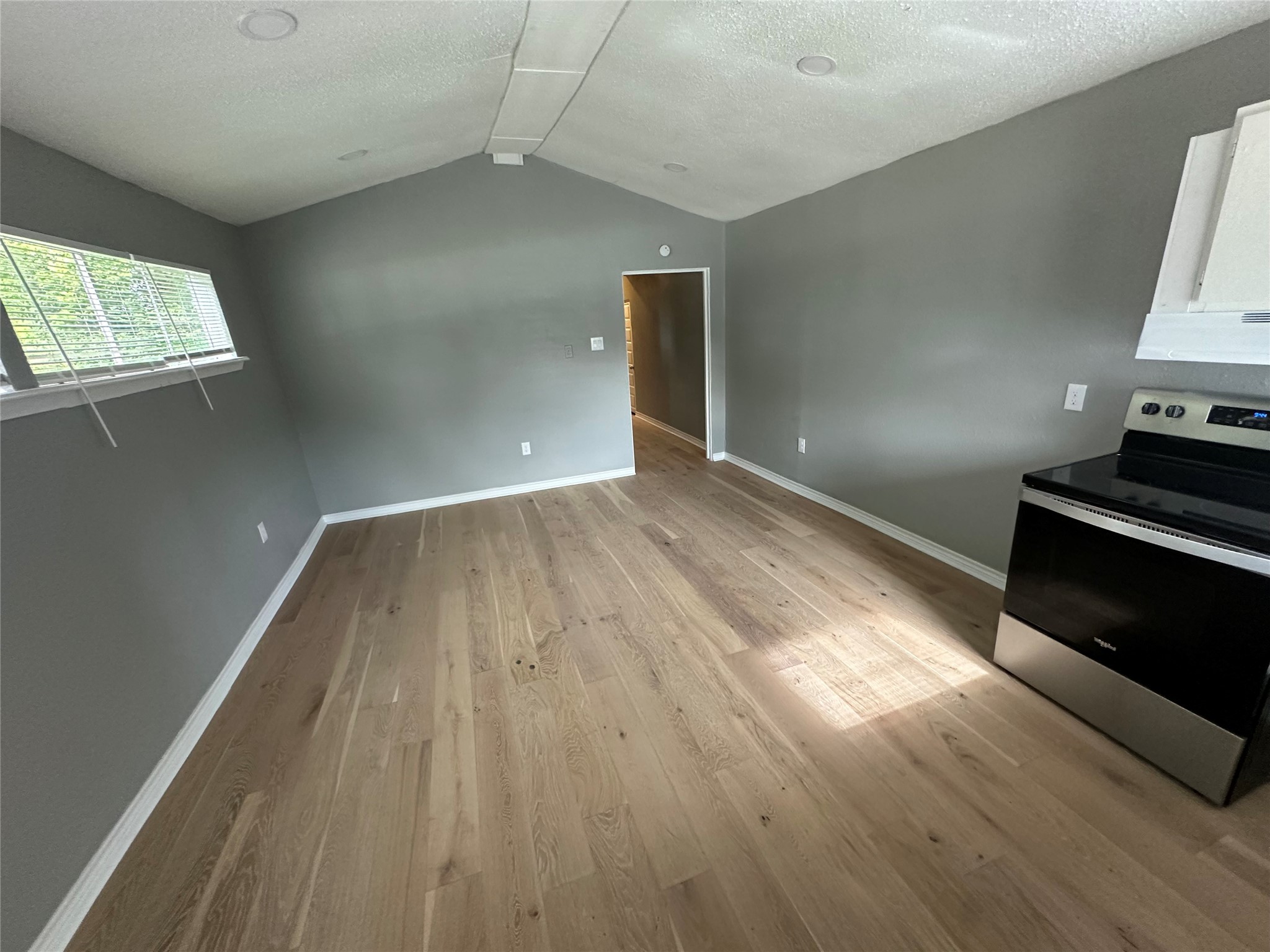 2131 Cromwell Street, Unit D Houston, TX 77093 - Photo 13 of 26 an empty room with wooden floor and windows