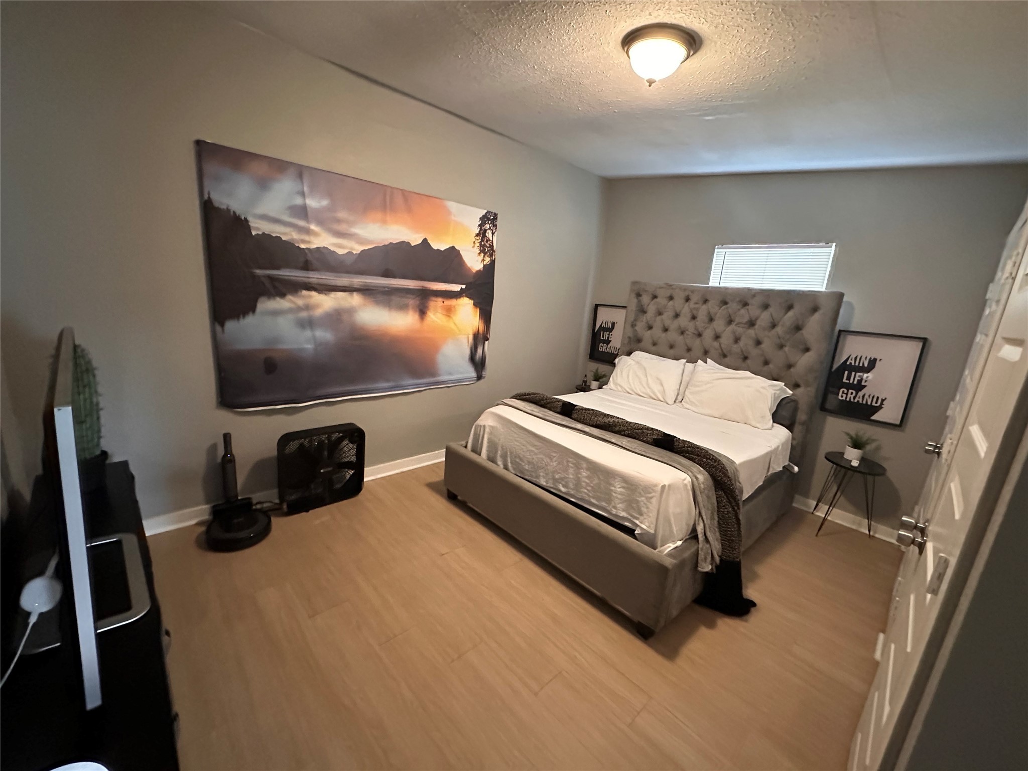 2131 Cromwell Street, Unit D Houston, TX 77093 - Photo 22 of 26 a bedroom with a bed and a flat screen tv