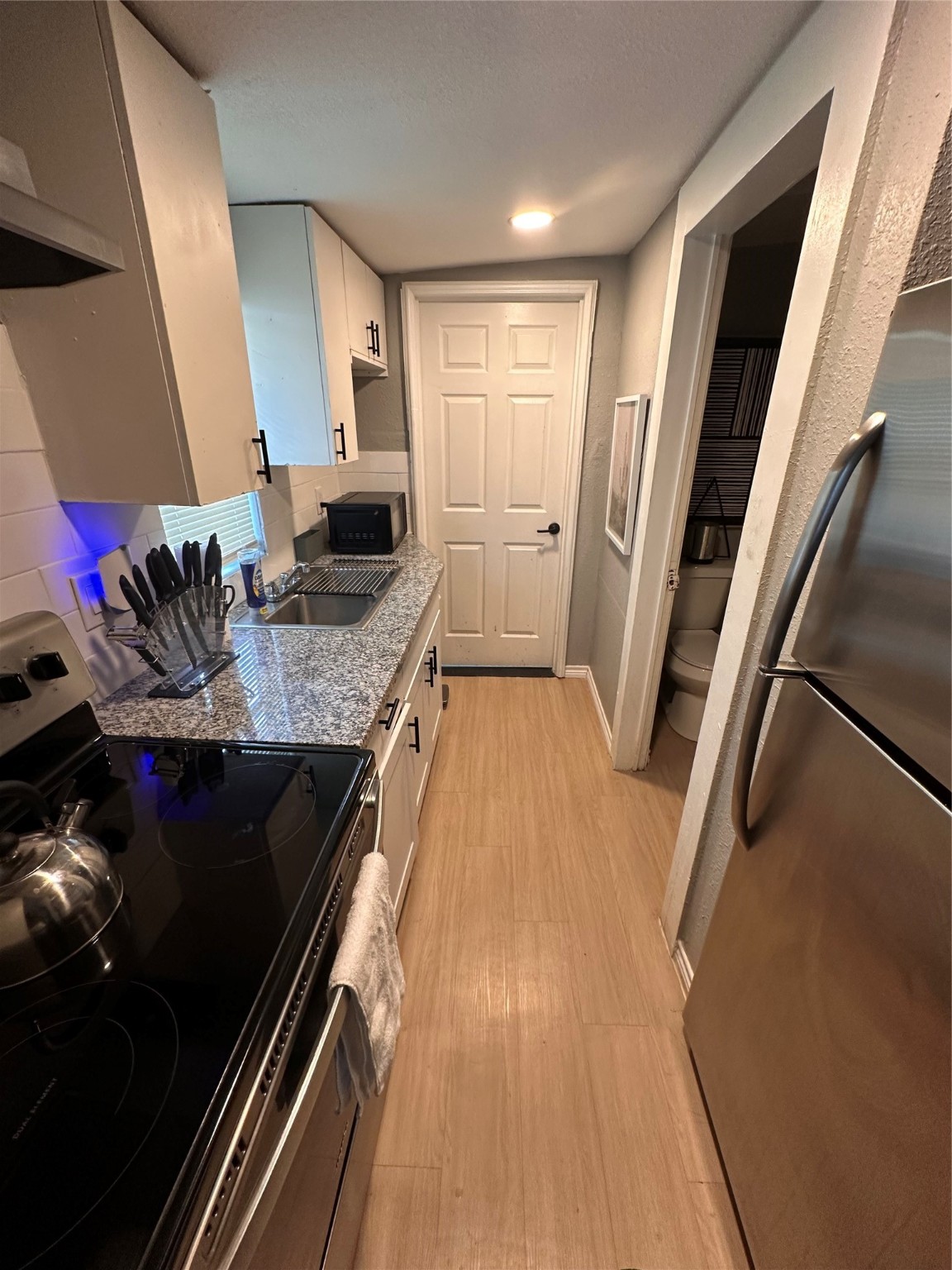 2131 Cromwell Street, Unit D Houston, TX 77093 - Photo 23 of 26 a kitchen with a sink and wooden floor