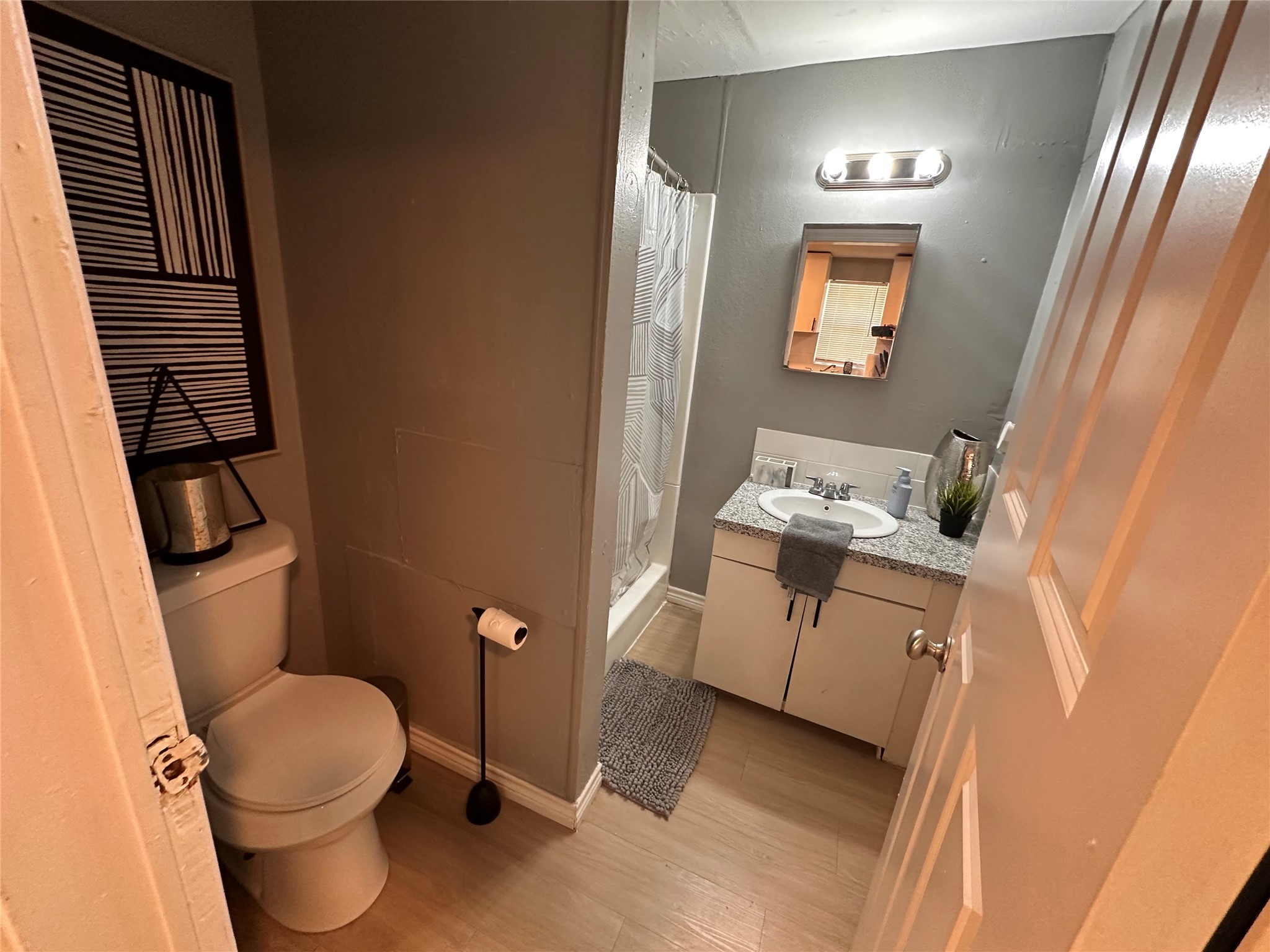 2131 Cromwell Street, Unit D Houston, TX 77093 - Photo 24 of 26 a bathroom with a toilet sink and mirror