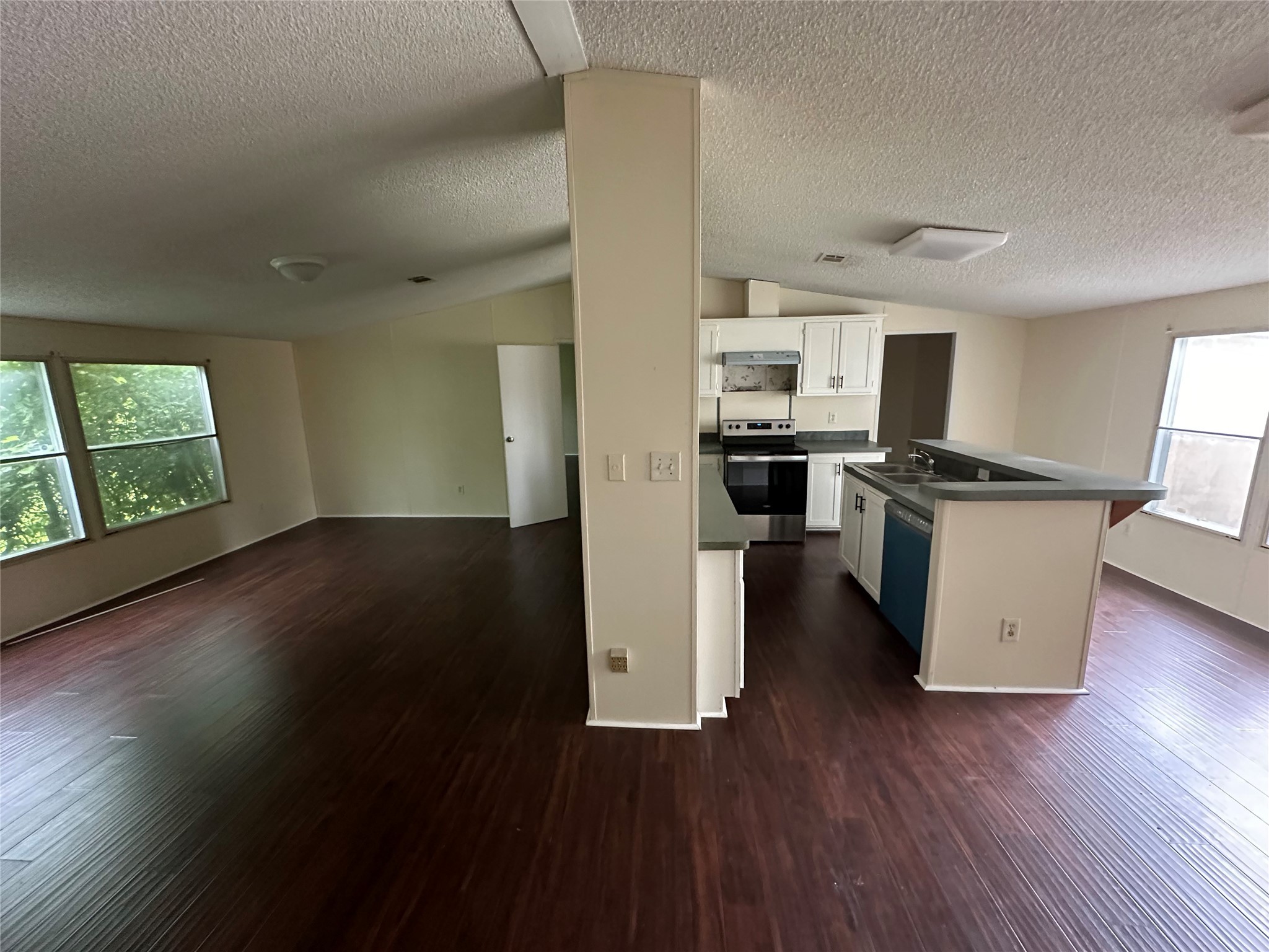 2131 Cromwell Street, Unit D Houston, TX 77093 - Photo 7 of 26 a kitchen with a wooden floor and a large window