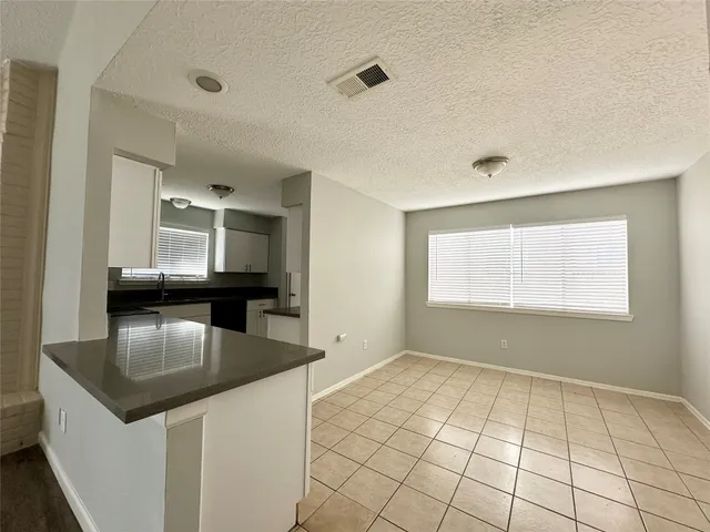 a view of kitchen with faucet cabinets and outdoor space