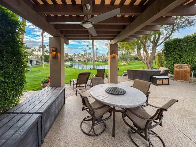 a view of an outdoor sitting area with furniture and garden view
